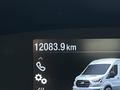 A digital display showing 12083.9 km with a graphic of a 2023 Ford Transit van