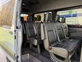 Interior view of a 2019 Mercedes-Benz Sprinter showing multiple black leather seats with seatbelts in a row