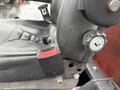 Close-up view of the seat and control mechanisms on a 2012 Kubota F3680 featuring a black seat with red lever and a gray adjustment knob