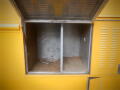 A yellow 2008 Freightliner MT45 Chassis with an open compartment revealing two empty sections inside the storage area