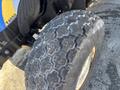 Close-up of a worn tire from a 2010 New Holland T4050 tractor showcasing a tread pattern with visible signs of usage and wear