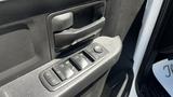 Close-up of the window and door lock controls on the driver's side of a 2019 RAM 3500 featuring multiple buttons and a textured surface