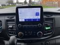 Interior dashboard of a 2021 Ford Transit featuring a central touchscreen display with audio settings and climate controls