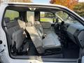 Interior view of a 2008 Ford F-150 XL showing two front seats and a spacious rear seating area with gray upholstery and console between the front seats