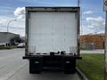 A white 2018 Hino 195 truck viewed from the rear with a smooth cargo area and visible tail lights on the underside of the rear bumper