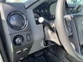 Interior dashboard of a 2013 Ford F-250 SD showing control knobs and gear shift lever