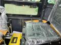2024 AGT Industrial Yellow H13R Mini Excavator operator's cabin featuring a seat and control levers wrapped in plastic protection