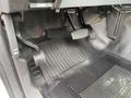 Foot pedals of a 2015 Ford F-250 SD including the brake and accelerator pedals with a rubber floor mat