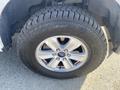 Close-up of a 2017 Ford F-150 wheel featuring a silver alloy rim and a rugged tire with visible tread patterns