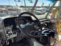 Interior view of a 2019 Freightliner MT45 showing the dashboard steering wheel and various controls