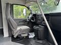 The interior of a 2020 Chevrolet Express showing the driver's seat and dashboard with controls and a steering wheel