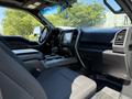 Interior view of a 2018 Ford F-150 showing front seats dashboard and center console with a touchscreen display