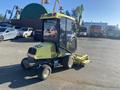 A 2010 Kubota F3680 lawn mower with a green and yellow cab and a front-mounted cutting deck parked on a lot
