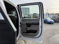 A 2020 Ford F-550 passenger door is open displaying the interior features and handle design