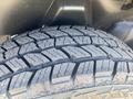 Close-up of a rugged tire from a 2021 RAM 1500 with an aggressive tread pattern designed for off-road performance and traction