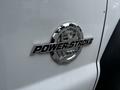 Close-up of a chrome badge on a 2011 Ford F-550 featuring the words 67 Powerstroke and B20