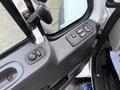 Interior control panel of a 2016 International 7400 featuring window and mirror adjustment buttons