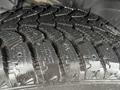 Close-up of a tire with a deep tread pattern designed for traction showcasing mud and water remnants on the surface