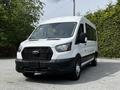 A 2022 Ford Transit van in white with a black grille and front bumper parked with no visible license plate