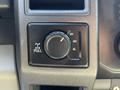 A close-up of a four-wheel drive control knob in a 2017 Ford F-350 SD featuring settings for 2H 4H and 4L with a pull mechanism
