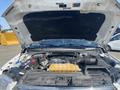 A 2017 Ford F-150 with its hood raised revealing the engine compartment including the air intake and coolant reservoir