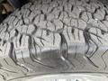 Close-up of a rugged tire tread on a 2016 Chevrolet Tahoe showcasing deep grooves and patterns designed for off-road traction