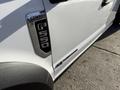 A white 2020 Ford F-550 truck with a prominent chrome badge displaying F-550 on the side panel and a sleek design