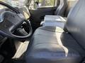 The interior of a 2008 International 7500 featuring a leather driver's seat and a passenger seat with a console in between