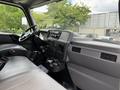 Interior view of a 2022 International MV607 truck showing the driver's seat dashboard and control panel