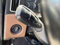 The image shows a close-up of a control stalk from a 2022 Freightliner Cascadia featuring turn signal and wiper controls alongside a dashboard switch for vehicle settings