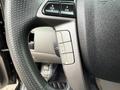Close-up of the steering wheel and control buttons of a 2014 Honda Odyssey showing volume and channel adjustments