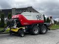 A 2020 Pottinger Impress 155 VC Pro baler with a red and white exterior featuring large wheels and attachments for hay or straw baling