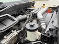 Engine compartment of a 2014 International TerraStar showing various components including hoses and a fluid reservoir