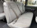 A gray upholstered bench seat with seatbelts in the rear of a 2021 Chevrolet Express van