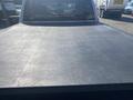 A 2021 RAM 1500 with a closed black tonneau cover on its truck bed