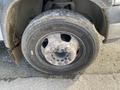 A close-up of a worn tire on a 2009 Dodge Ram 5500 showing visible dirt and wear on the tire surface and rim