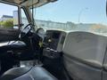 Interior view of a 2009 International 7500 showing the driver's seat dashboard and steering wheel with various controls and storage compartments