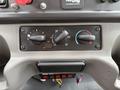 Control panel of a 2005 Freightliner M2 106 featuring knobs for temperature and fan settings along with various switches and indicator lights