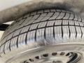 Close-up of a tire from a 2013 Ford Transit Connect showing detailed tread patterns and grooves