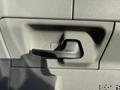 Close-up of a black door handle on the side of a 2011 Ford Econoline with textured gray interior panel