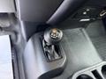 A close-up of the gear shift lever inside a 2018 Ford F-350 with a textured grip and markings indicating shifting positions