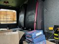 The interior of a 2009 Spartan Gladiator showing two front seats and boxes stacked on the floor including items labeled as wheel seals
