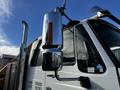 A 2013 International DuraStar 4300 truck with a shiny chrome exhaust stack and side mirror visible in the foreground