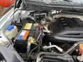 Close-up of the engine compartment of a 2016 Ford F-150 showcasing the battery and various engine components
