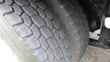 A close-up of a treaded tire from a 2012 International 7400 showing detailed patterns and grooves for traction