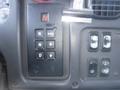 A control panel featuring a gear shift lever with buttons for neutral reverse drive and mode alongside various switches for vehicle functions