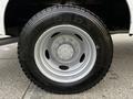 Close-up of a silver alloy wheel with a large road tire mounted on a 2016 Ford F-550