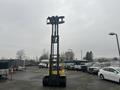 A yellow 2000 Hyster 120 forklift with a tall lifting mechanism in an upright position