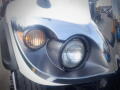 Close-up of the front headlights of a 2016 International WorkStar 7500 with chrome detailing and one amber light and one clear headlight