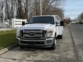 A 2016 Ford F-350 SD is parked with a white body and chrome grille featuring multiple orange lights on the roof and heading towards the viewer